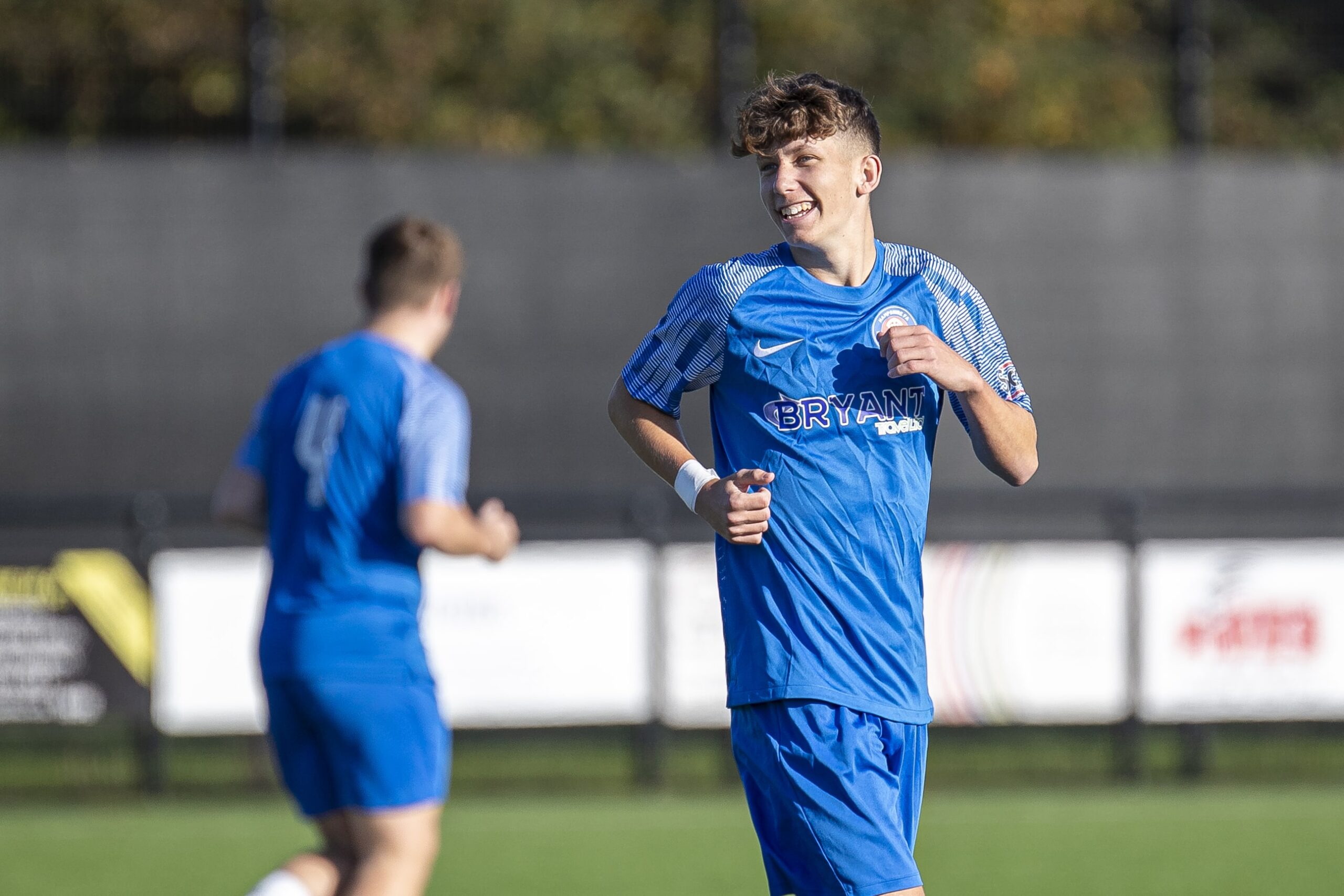 Hampshire FA Academy player smiling on the pitch.