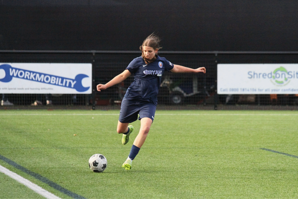 HFA Academy player kicking the ball